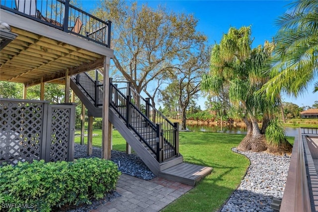 view of yard featuring stairway and a water view