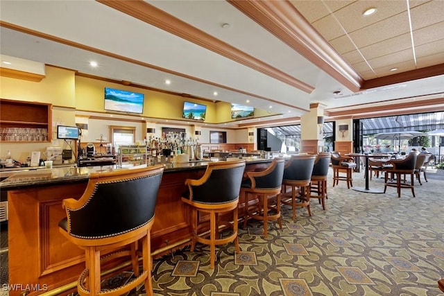 bar featuring crown molding, a tray ceiling, carpet floors, a community bar, and recessed lighting