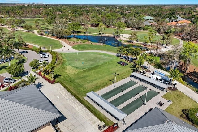 birds eye view of property with a water view and golf course view