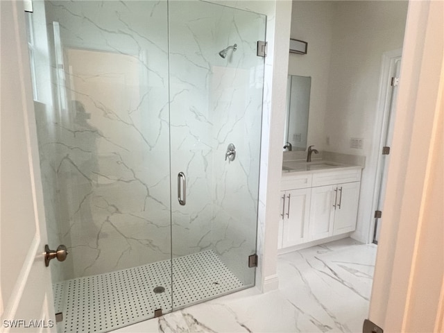 full bath with vanity, marble finish floor, and a marble finish shower