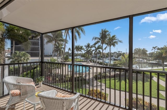 sunroom / solarium featuring plenty of natural light and a water view