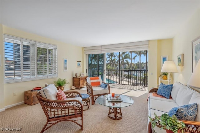 carpeted living room with baseboards