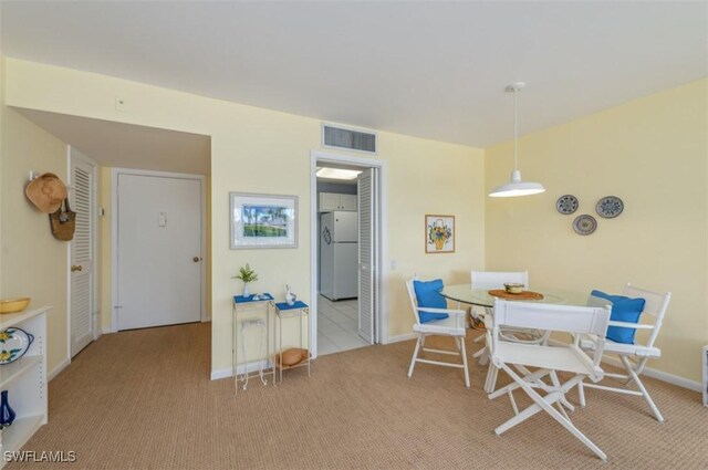 dining space featuring visible vents, baseboards, and carpet flooring