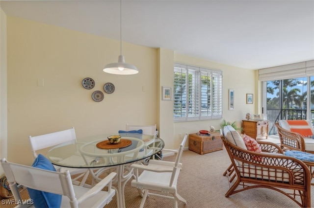 carpeted dining area with baseboards