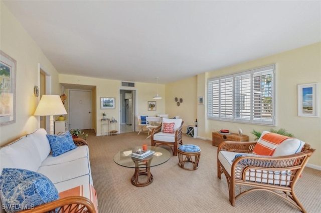 carpeted living room with visible vents and baseboards