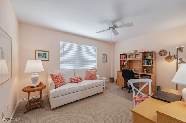 office featuring baseboards, a ceiling fan, and carpet