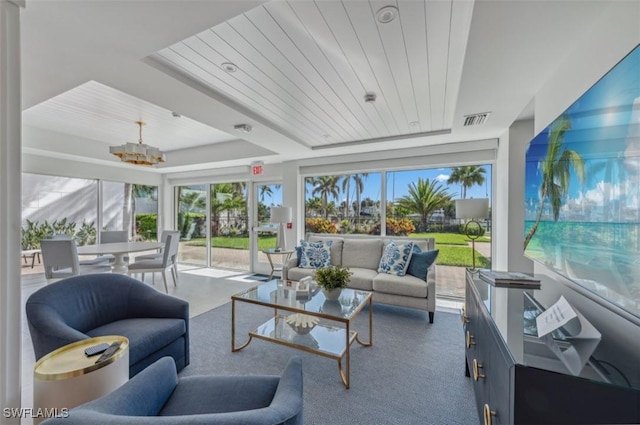 sunroom / solarium featuring visible vents, wood ceiling, a tray ceiling, and an inviting chandelier