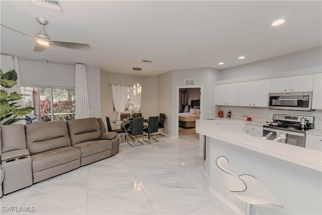 kitchen with stainless steel appliances, visible vents, open floor plan, and light countertops