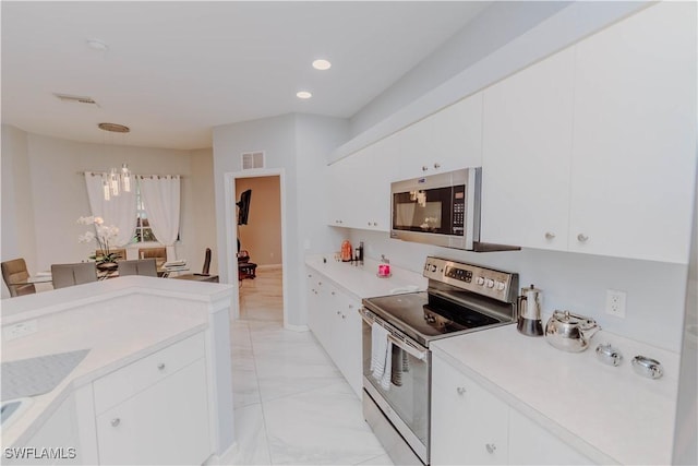 kitchen with visible vents, light countertops, appliances with stainless steel finishes, marble finish floor, and white cabinetry