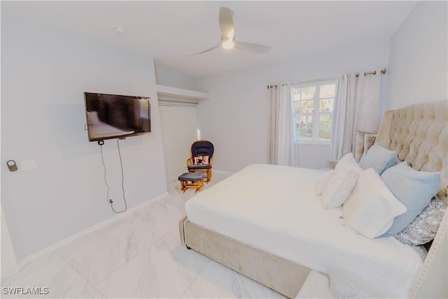 bedroom featuring marble finish floor and ceiling fan