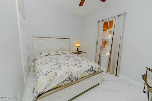 bedroom with marble finish floor, a ceiling fan, and baseboards