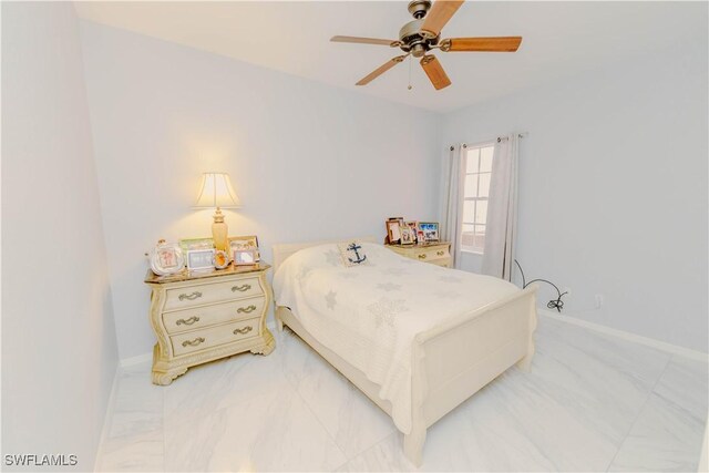 bedroom featuring baseboards, marble finish floor, and ceiling fan