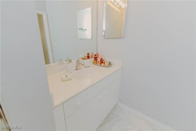 bathroom featuring vanity, baseboards, and marble finish floor