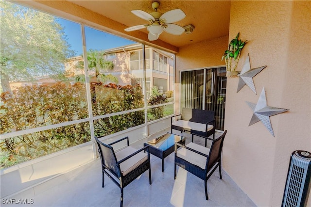 sunroom featuring heating unit and a ceiling fan