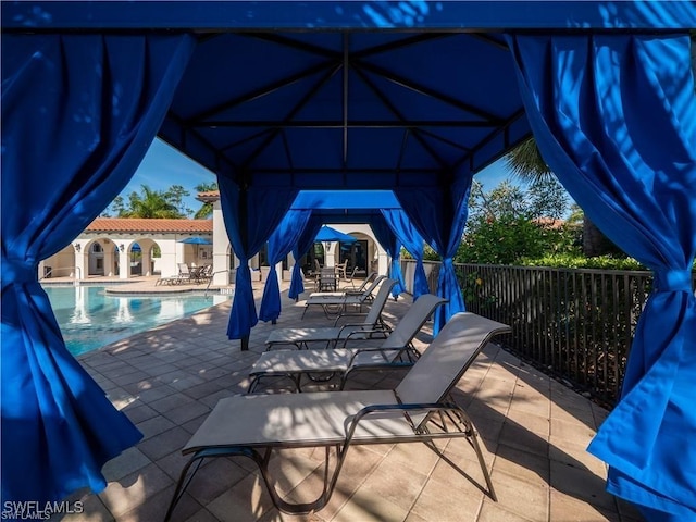 view of patio / terrace with a gazebo and a community pool