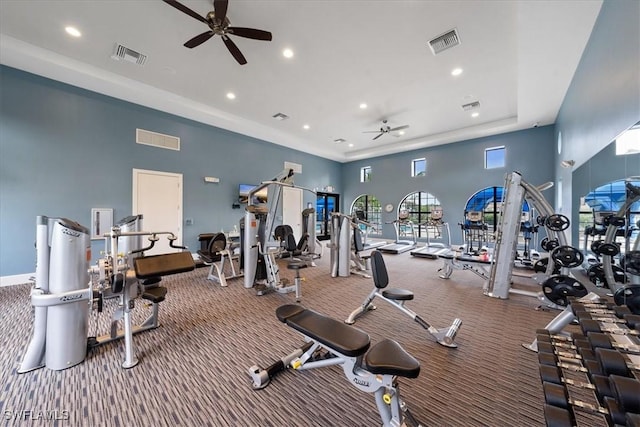 gym featuring a ceiling fan, visible vents, and carpet