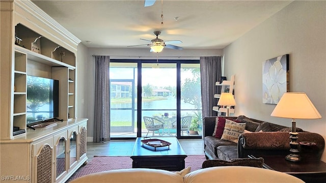 living room with ceiling fan and wood finished floors