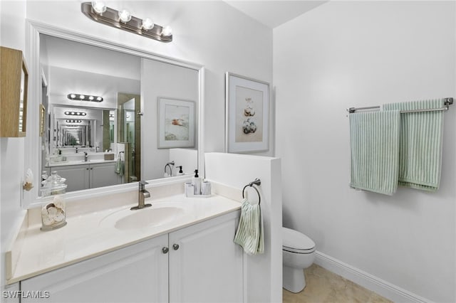 full bathroom with vanity, toilet, baseboards, and a shower with door