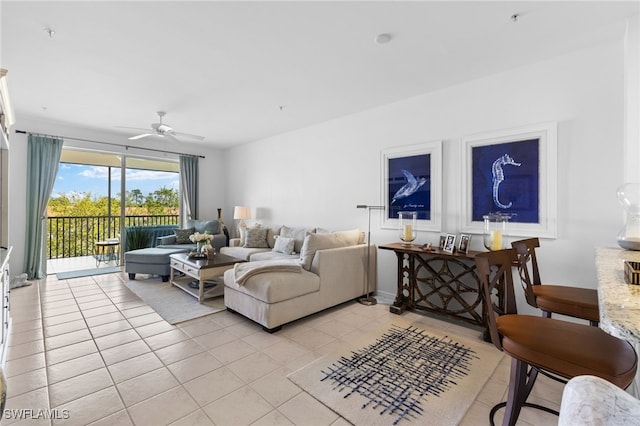 living area with light tile patterned floors and ceiling fan