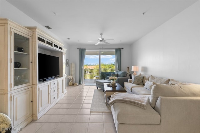 living room featuring light tile patterned floors, visible vents, and a ceiling fan