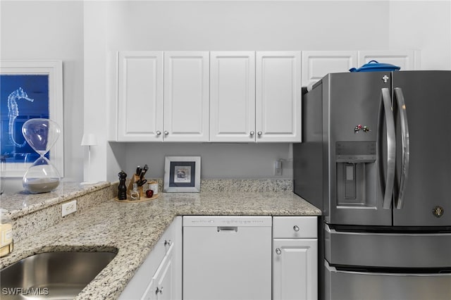 kitchen with stainless steel fridge, dishwasher, and white cabinetry