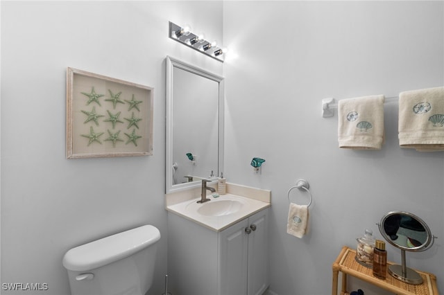 half bathroom with vanity and toilet