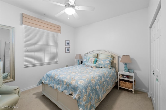 bedroom featuring a closet, baseboards, carpet, and a ceiling fan