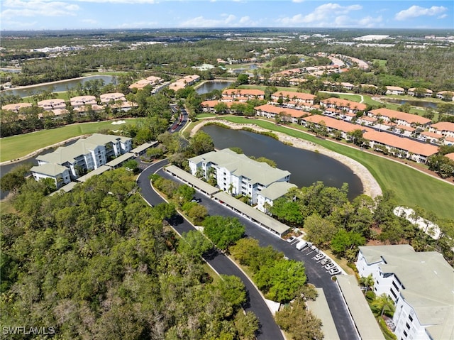 aerial view featuring golf course view, a water view, and a residential view