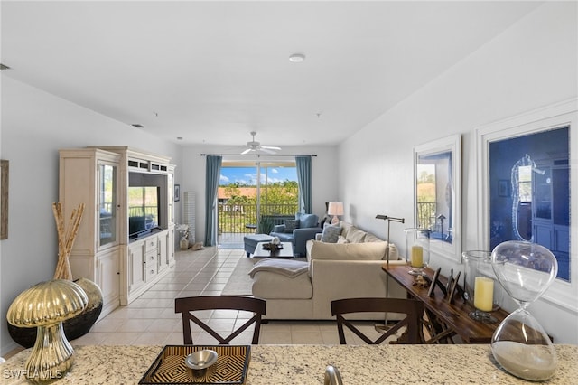 living room featuring light tile patterned flooring, a ceiling fan, and visible vents