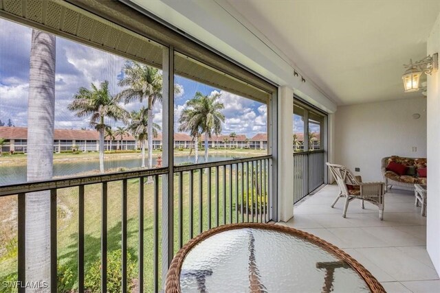 2381 Hidden Lake Ct Unit 8202, Naples, FL 34112 - sunroom with a water view and tile patterned floors