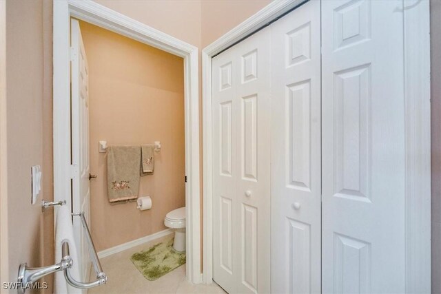 2381 Hidden Lake Ct Unit 8202, Naples, FL 34112 - bathroom with a closet, toilet, baseboards, and tile patterned floors