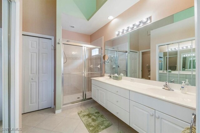 2381 Hidden Lake Ct Unit 8202, Naples, FL 34112 - full bath with tile patterned flooring, a closet, double vanity, and a stall shower