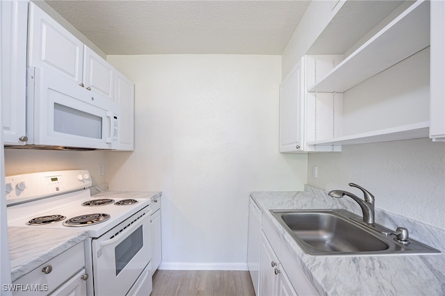 4605 Bayshore Dr Unit G6, Naples, FL 34112 - kitchen with white appliances, open shelves, white cabinetry, light countertops, and a textured ceiling