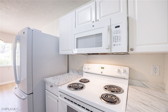 4605 Bayshore Dr Unit G6, Naples, FL 34112 - kitchen with white appliances, light countertops, white cabinetry, and a textured ceiling