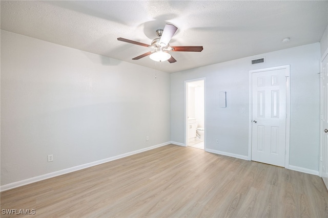 4605 Bayshore Dr Unit G6, Naples, FL 34112 - empty room with light wood-style flooring, a ceiling fan, and a textured ceiling