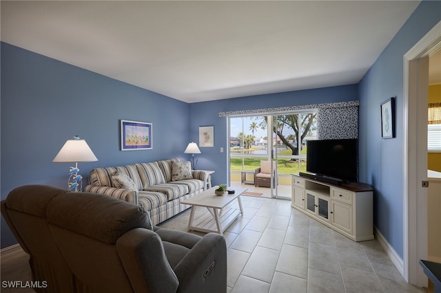 living area with light tile patterned floors and baseboards