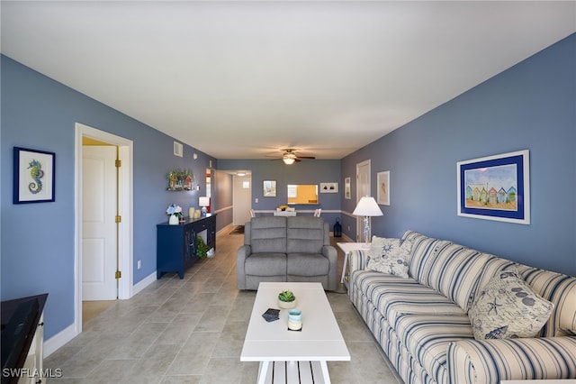 living room with baseboards and ceiling fan