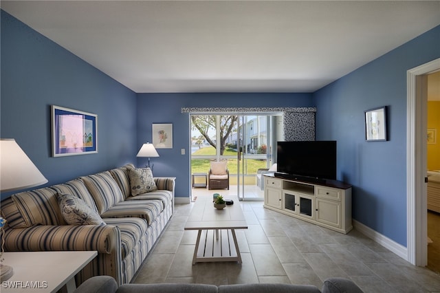 living room with light tile patterned floors and baseboards