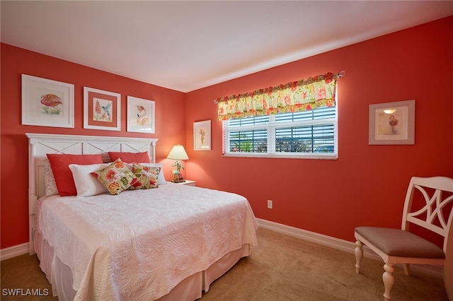 carpeted bedroom featuring baseboards