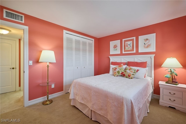 bedroom with visible vents, baseboards, a closet, and carpet flooring