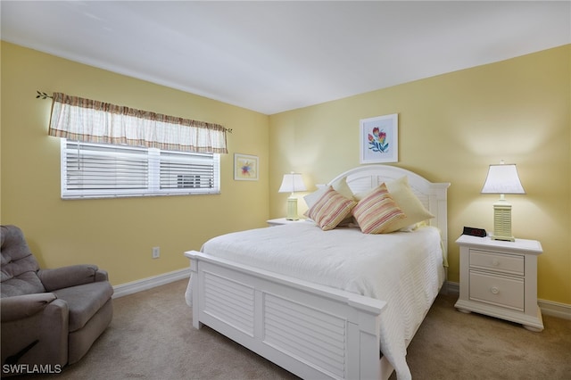 carpeted bedroom featuring baseboards