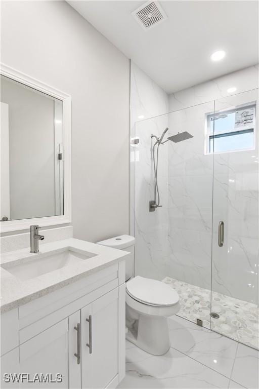 full bathroom featuring visible vents, toilet, marble finish floor, a marble finish shower, and vanity