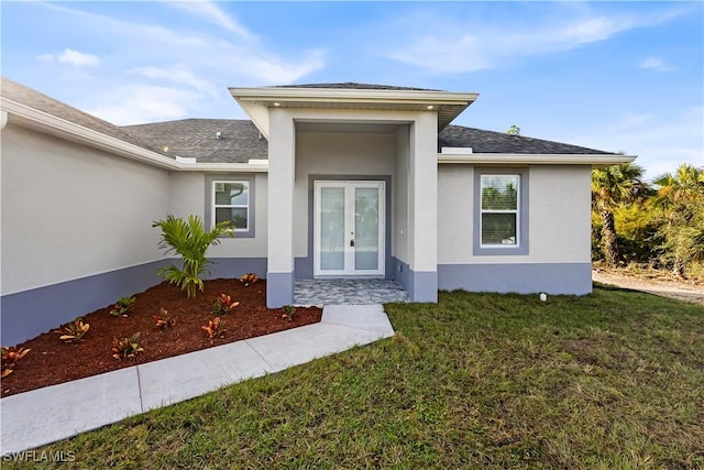 entrance to property with stucco siding, french doors, and a shingled roof