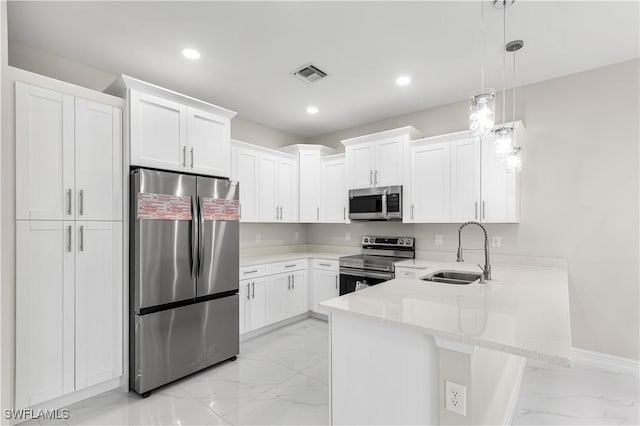 kitchen featuring visible vents, marble finish floor, a sink, stainless steel appliances, and a peninsula