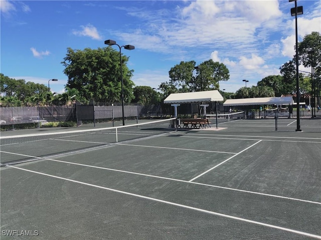 view of sport court featuring fence