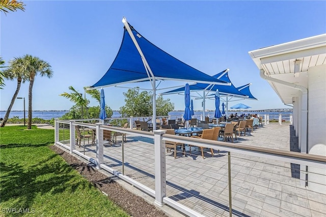 view of patio with outdoor dining space and a water view