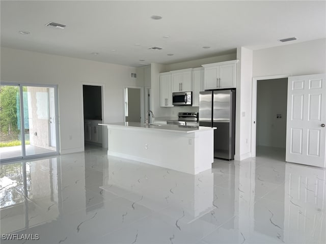 kitchen featuring visible vents, white cabinets, appliances with stainless steel finishes, and marble finish floor