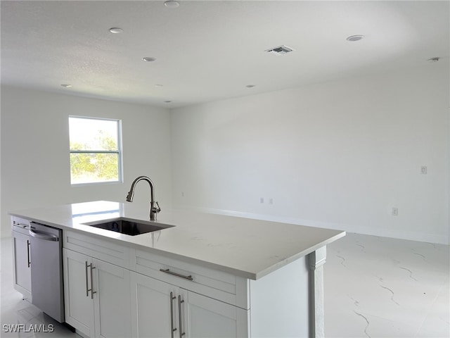 kitchen with visible vents, a sink, baseboards, white cabinetry, and stainless steel dishwasher