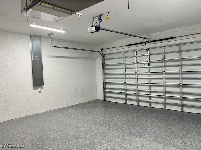 garage featuring electric panel and a garage door opener