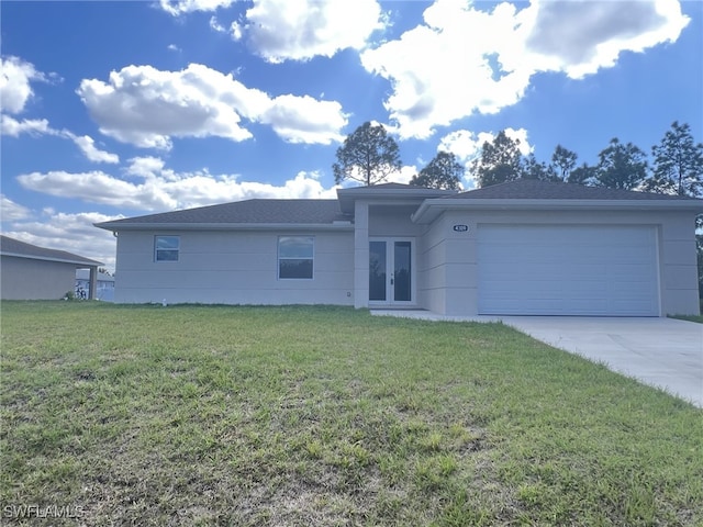 view of front of property with french doors, driveway, a garage, and a front lawn